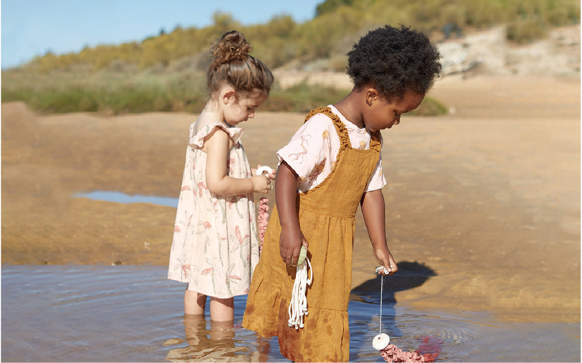 Play Up brand image of two children on the beach