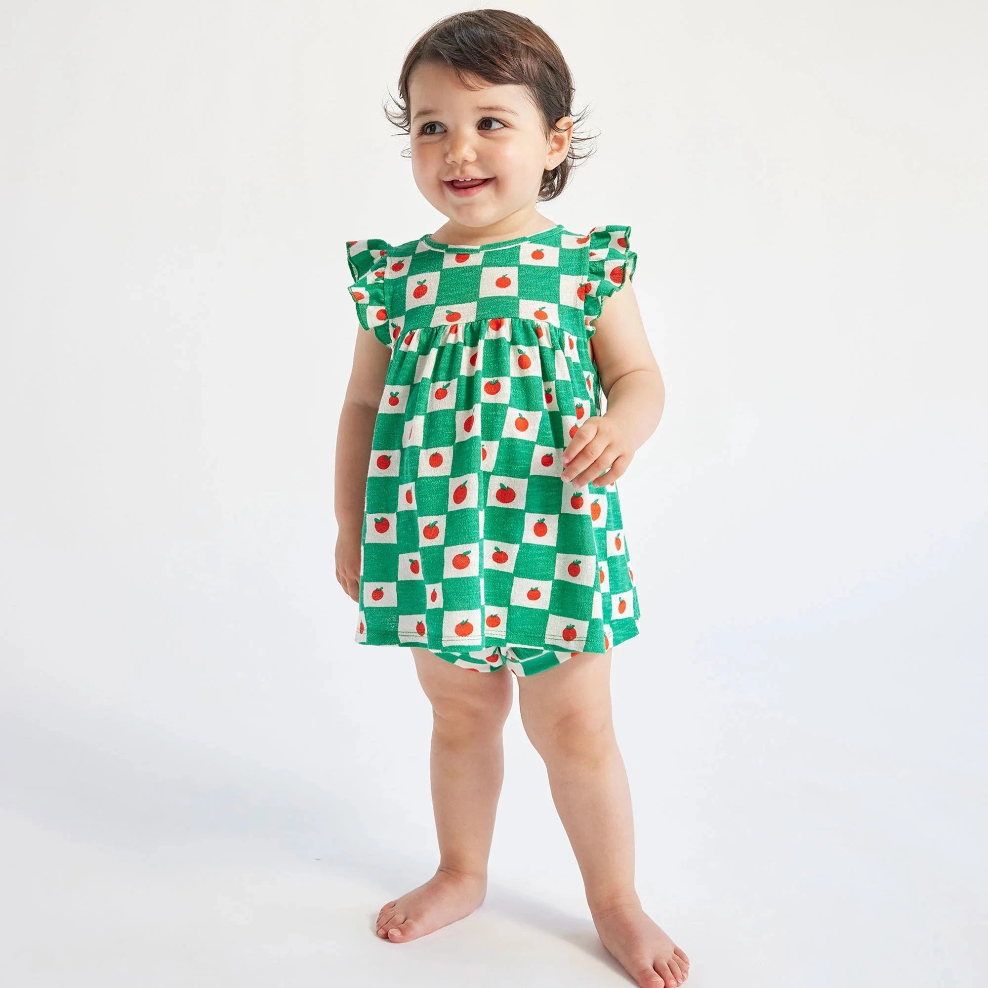 child stand gin green and white checked print with little red tomatoes dress