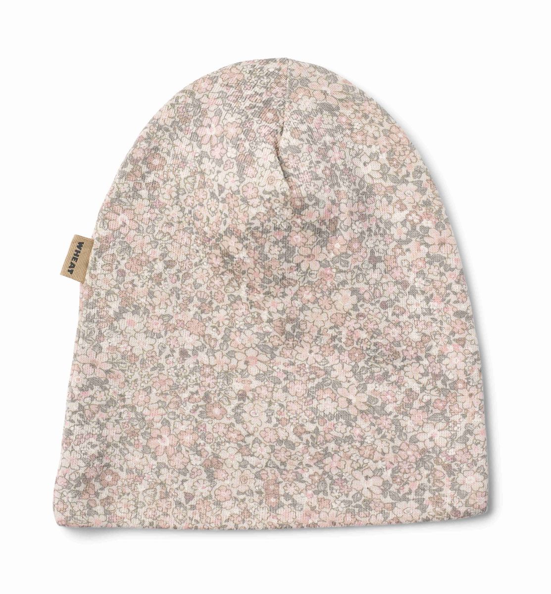 A knit beanie hat featuring a dense, small-scale floral pattern in soft pink, dusty rose, and muted gray on a light cream base. A small tan fabric brand tag is visible on the left side