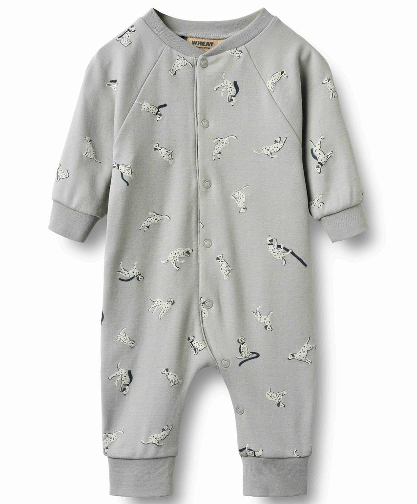 A baby's long-sleeve light gray footless romper with an all-over dog print, featuring snap closures down the front and ribbed cuffs and leg openings.