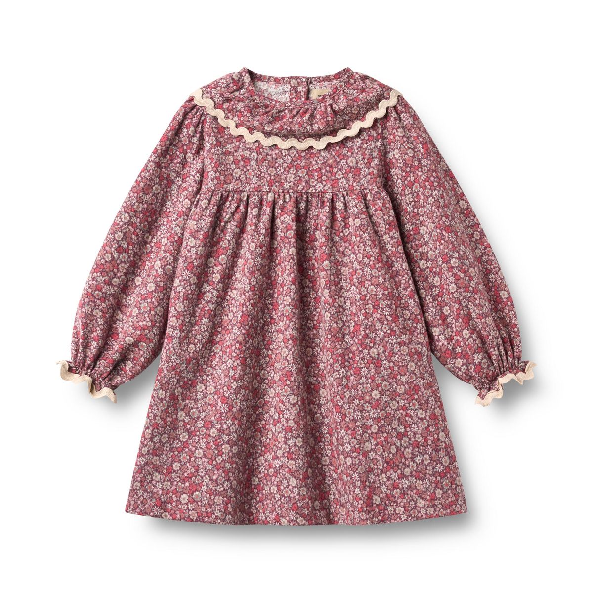 A long-sleeve children's dress with a dense small floral print in dusty pink, red, and cream, featuring a scalloped cream collar and matching cream trim at the cuffs, shown flat on a white background.