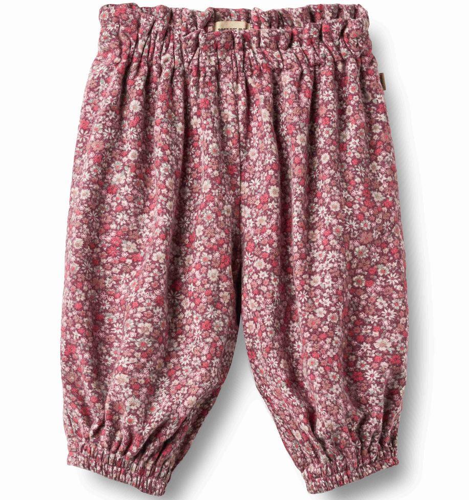 A pair of baby/toddler elastic-waist and elastic-calf pants in a dusty rose and pink floral print, shown flat on a white background.