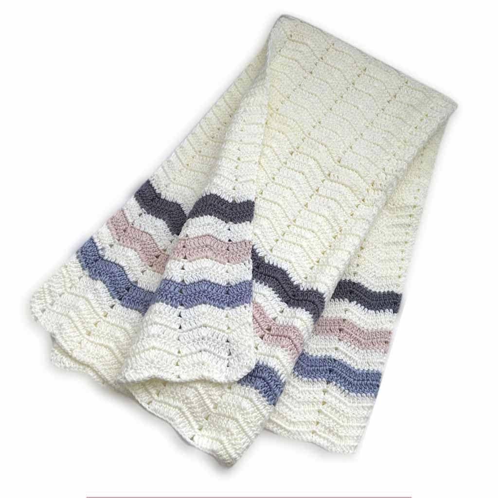 Knitted blanket with wavy pattern on a white background