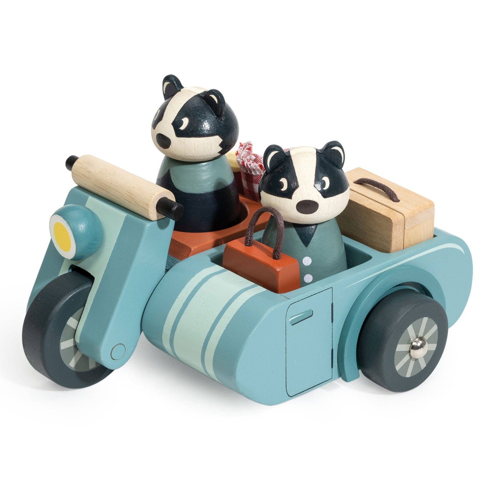 Wooden toy set with a scooter, picnic basket, and two badger figures on a red checkered cloth.