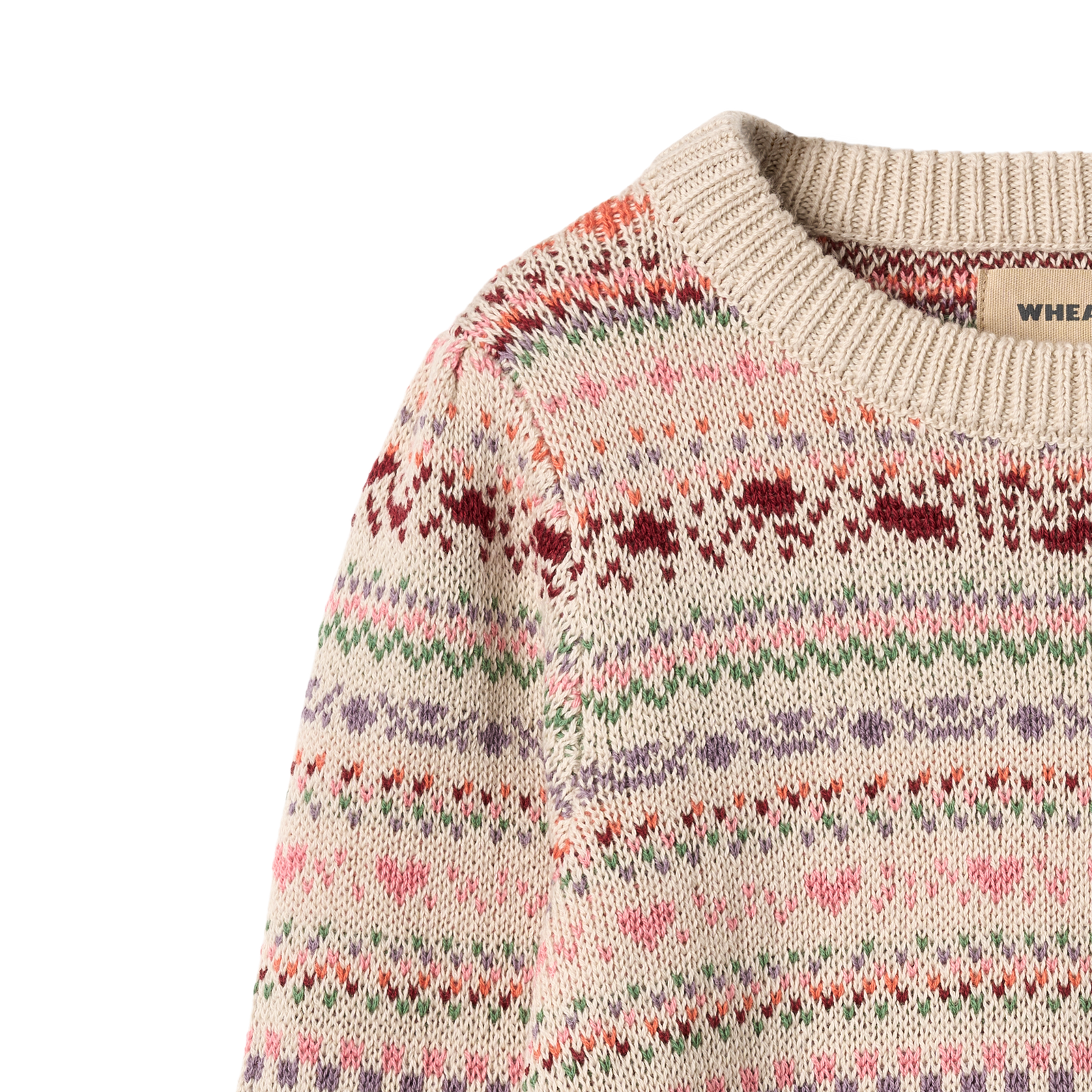 Child wearing patterned sweater on grey background