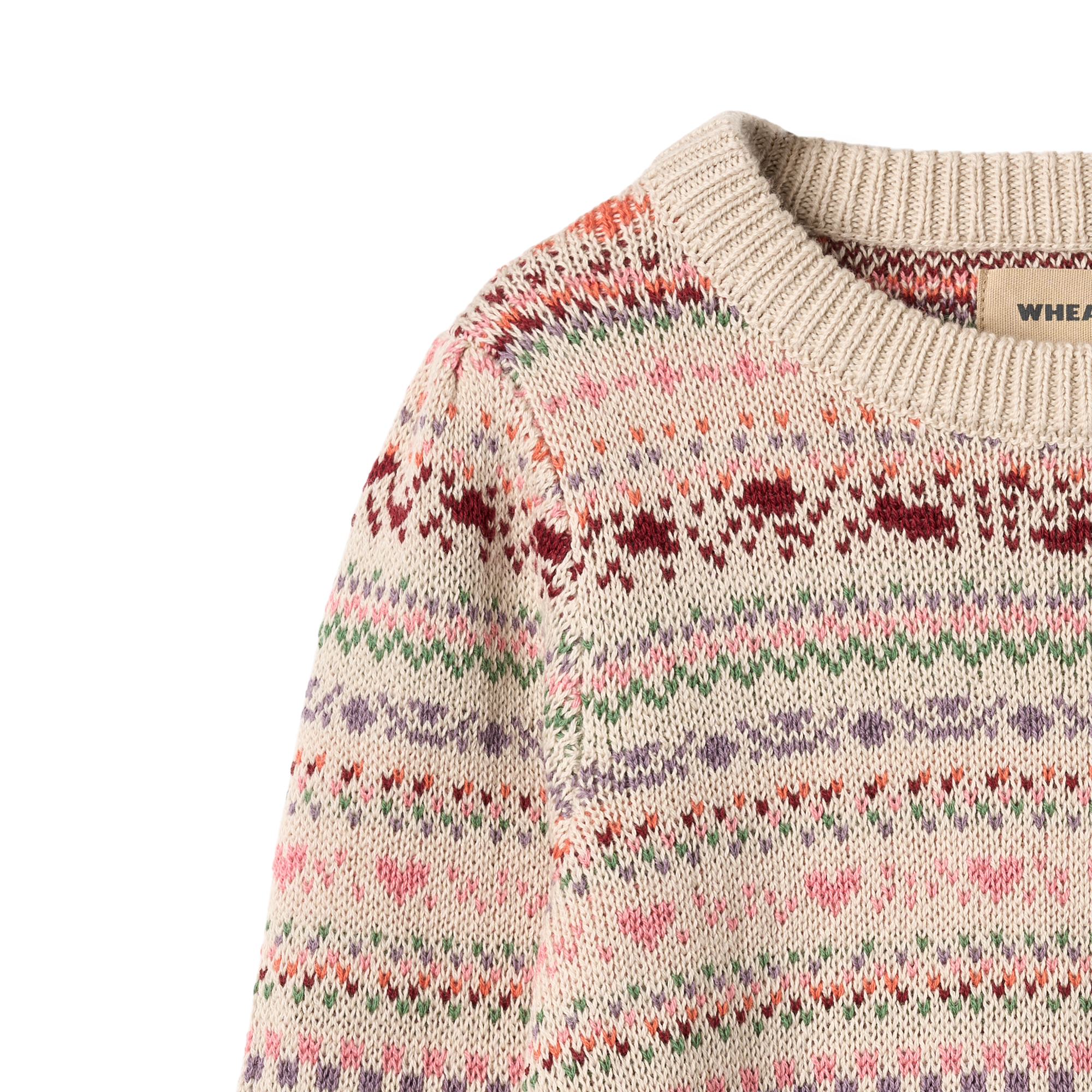 Child wearing patterned sweater on grey background