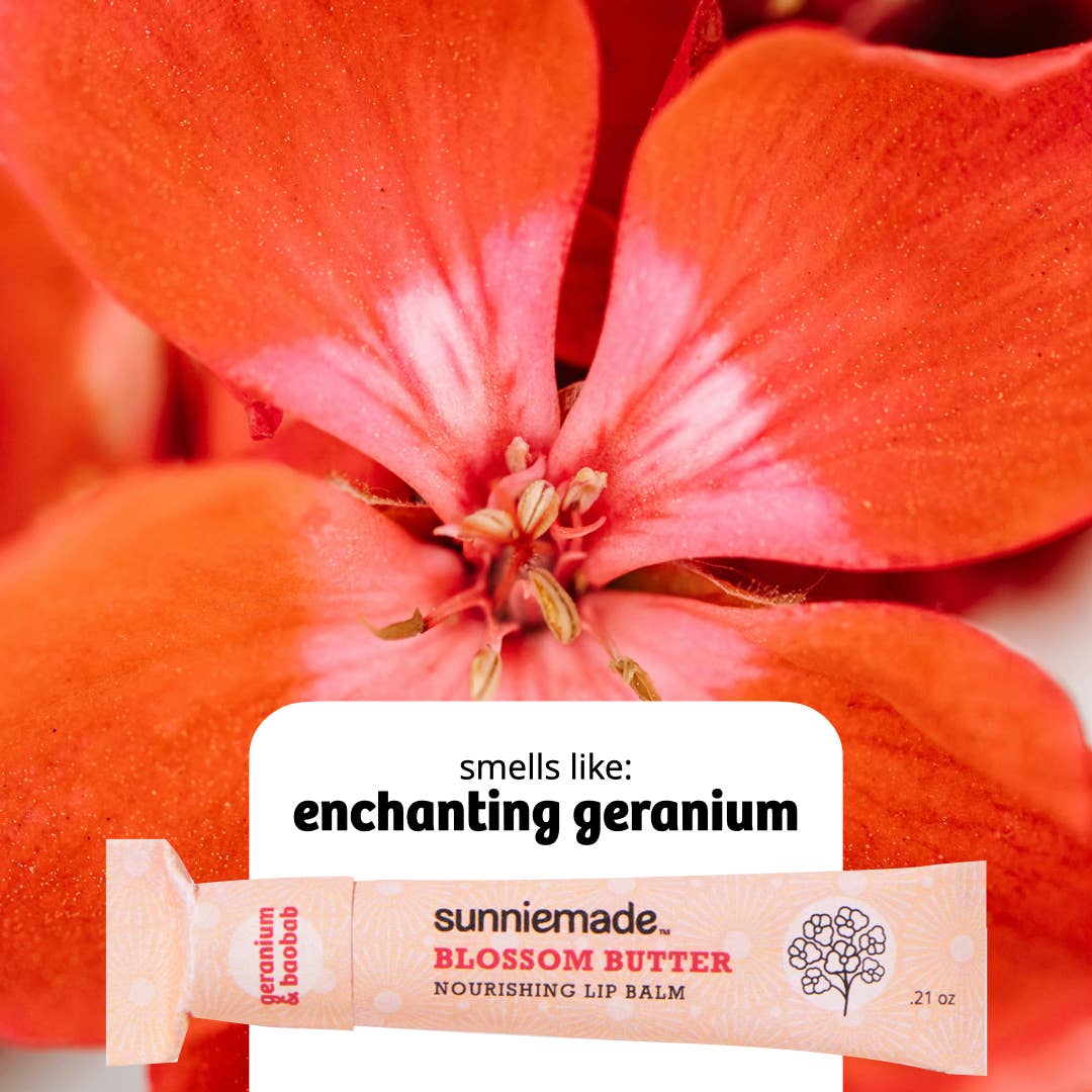Sunniemade Blossom Butter lip balm with a red flower in the background