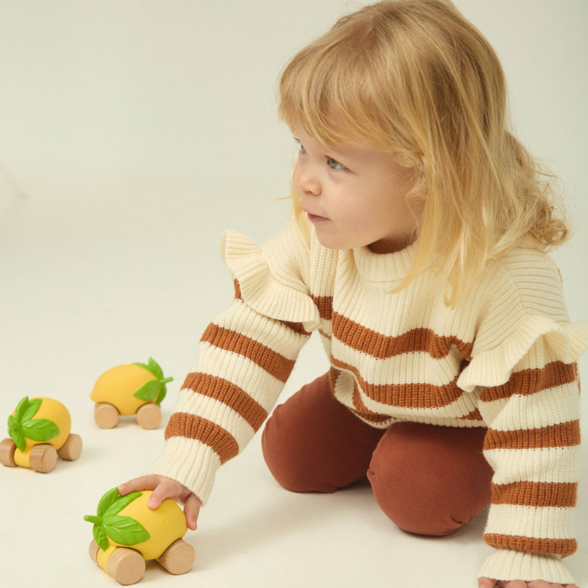 Child playing with toys on a plain background