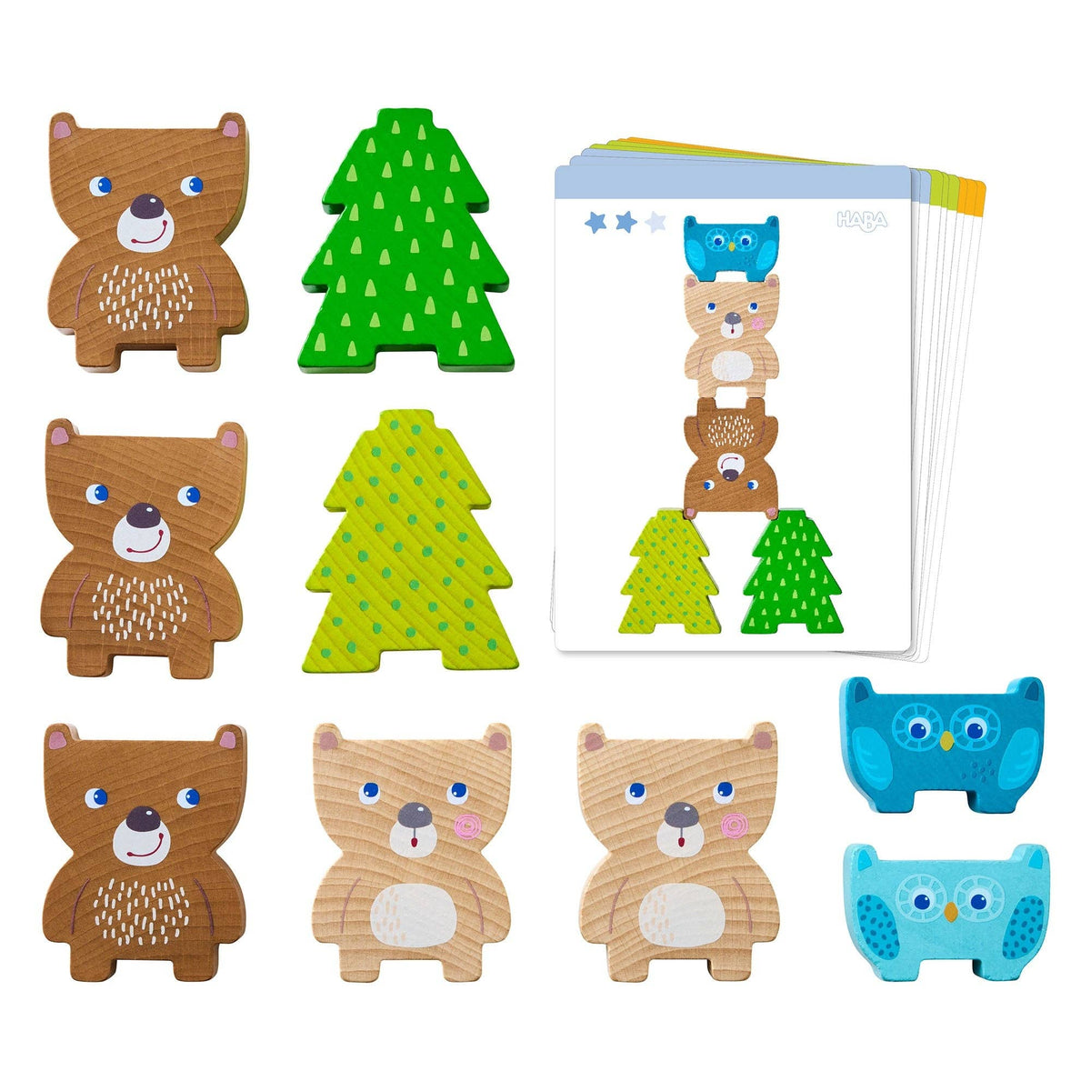 Set of wooden animal toys including bears, trees, and an owl on a white background