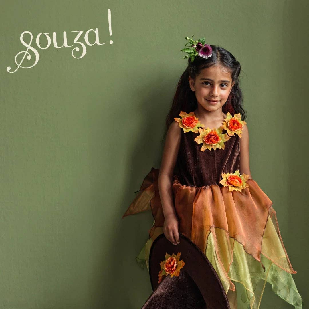 Children's dress with floral decorations on a mannequin against a white background