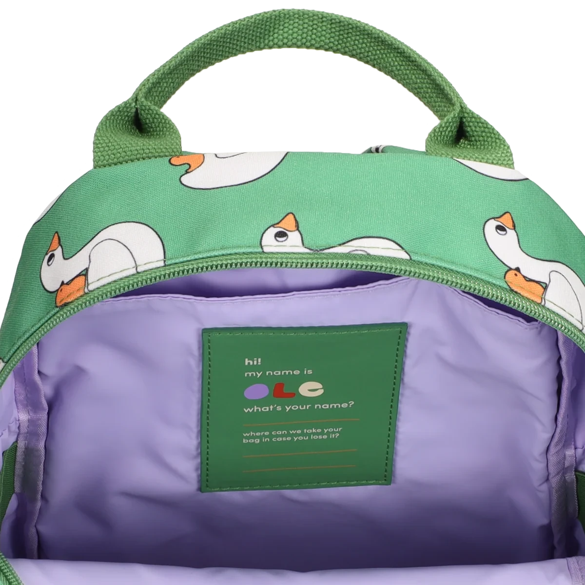A green backpack with a white swan print pattern, shown open to reveal a light purple interior. The front pocket features a green patch with a cute message and a small duck illustration.