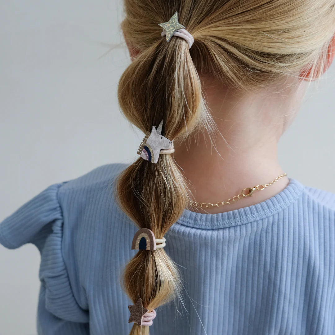 Set of decorative ponies with unicorn, star, and rainbow designs on a white background.