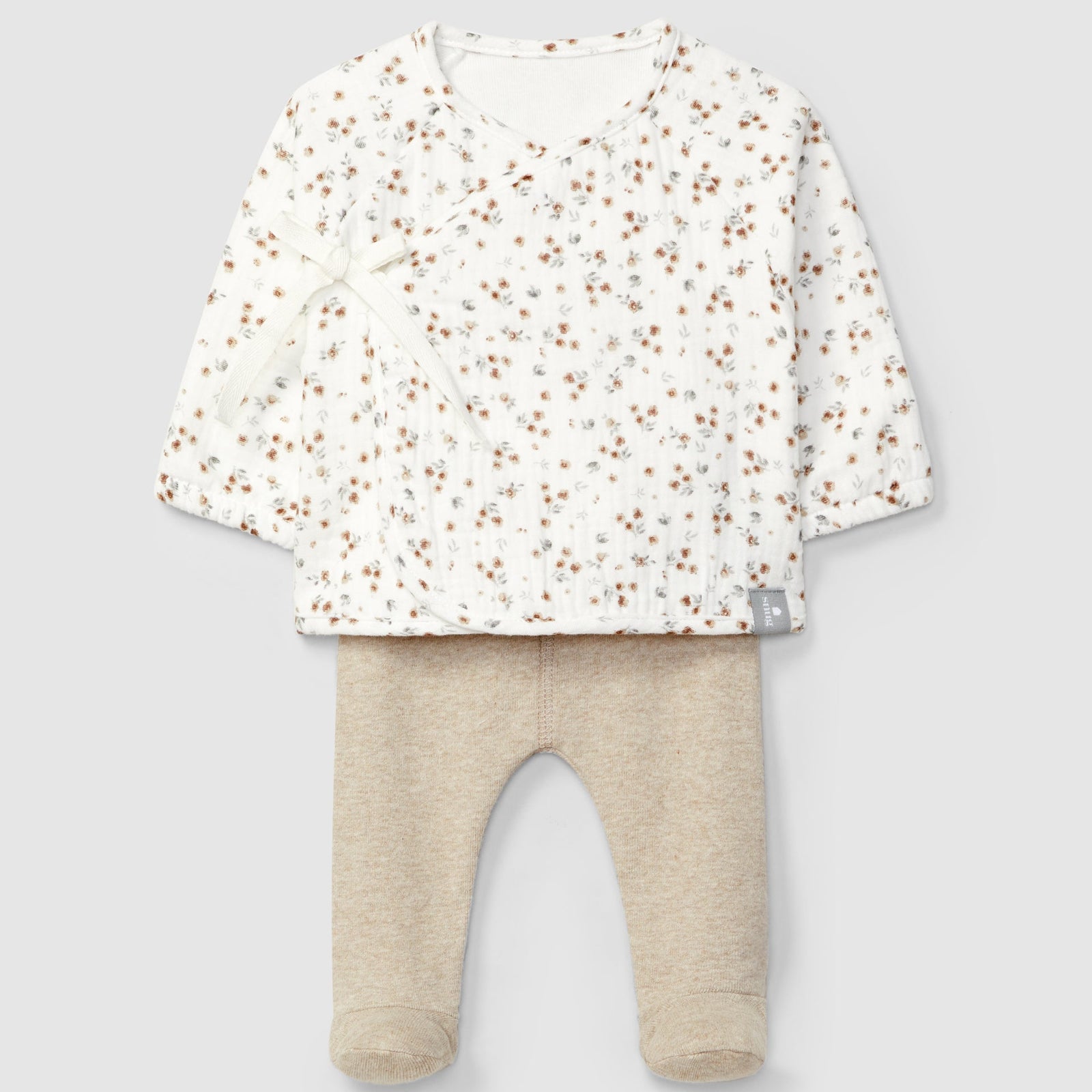 Baby outfit with floral top and beige pants on a light gray background