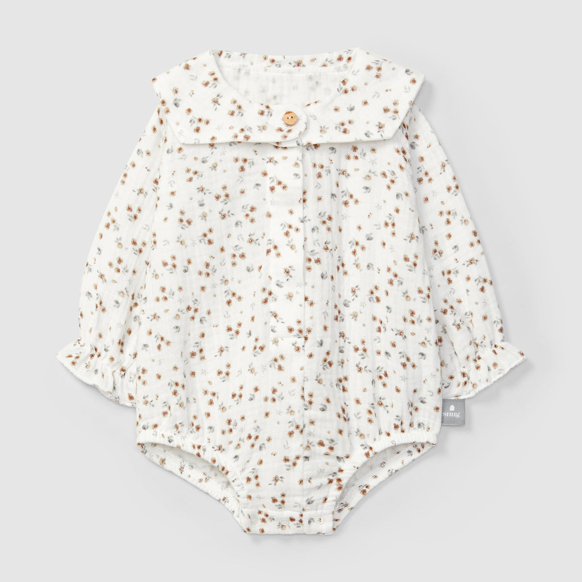 Floral-patterned baby romper on a light gray background