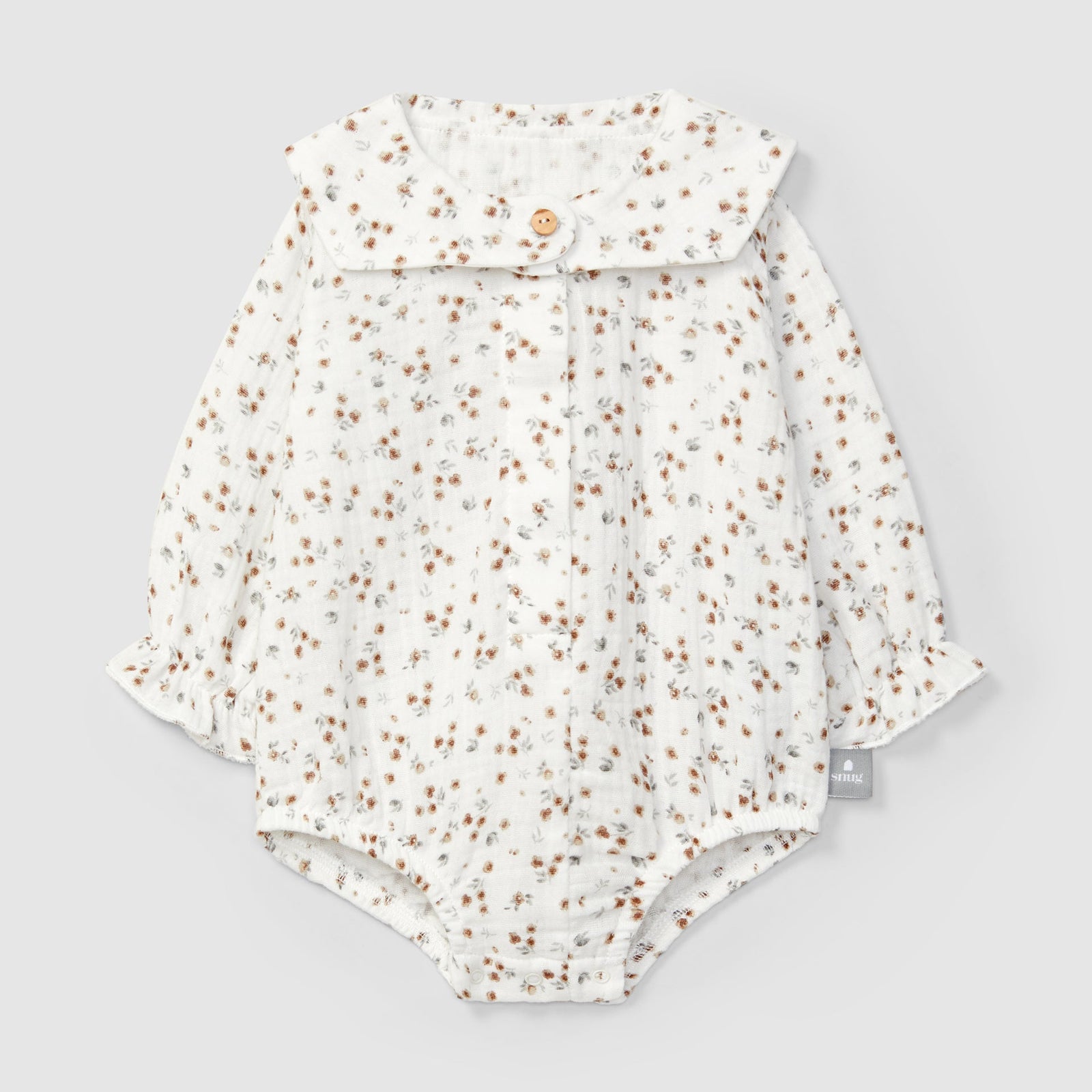 Floral-patterned baby romper on a light gray background