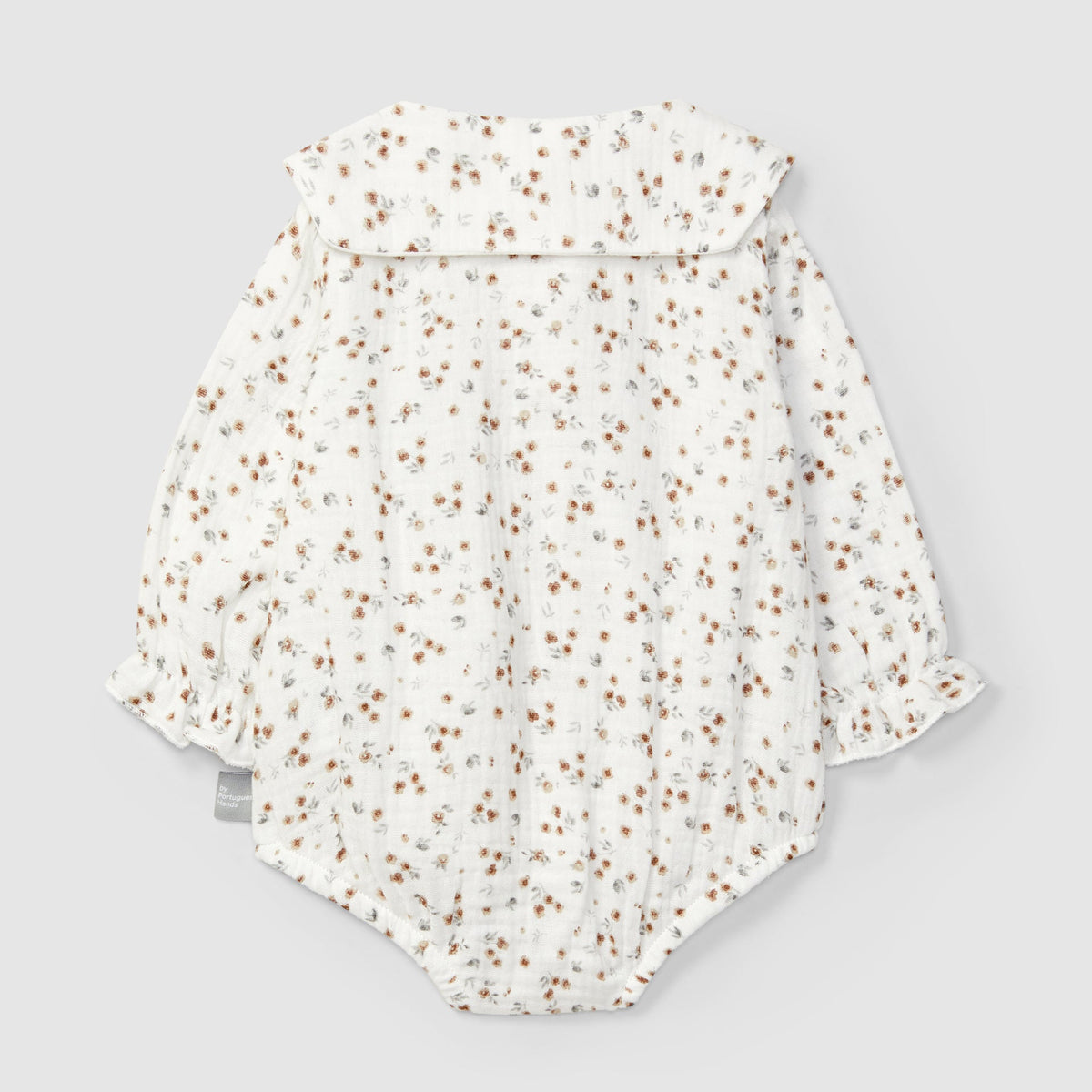 Floral-patterned baby romper on a light gray background