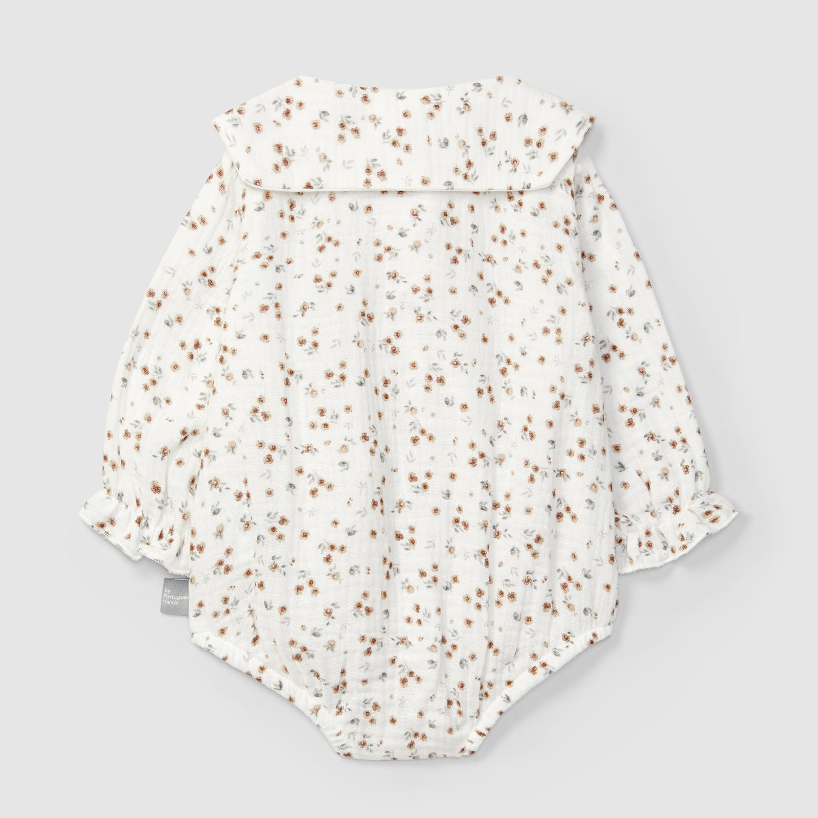 Floral-patterned baby romper on a light gray background