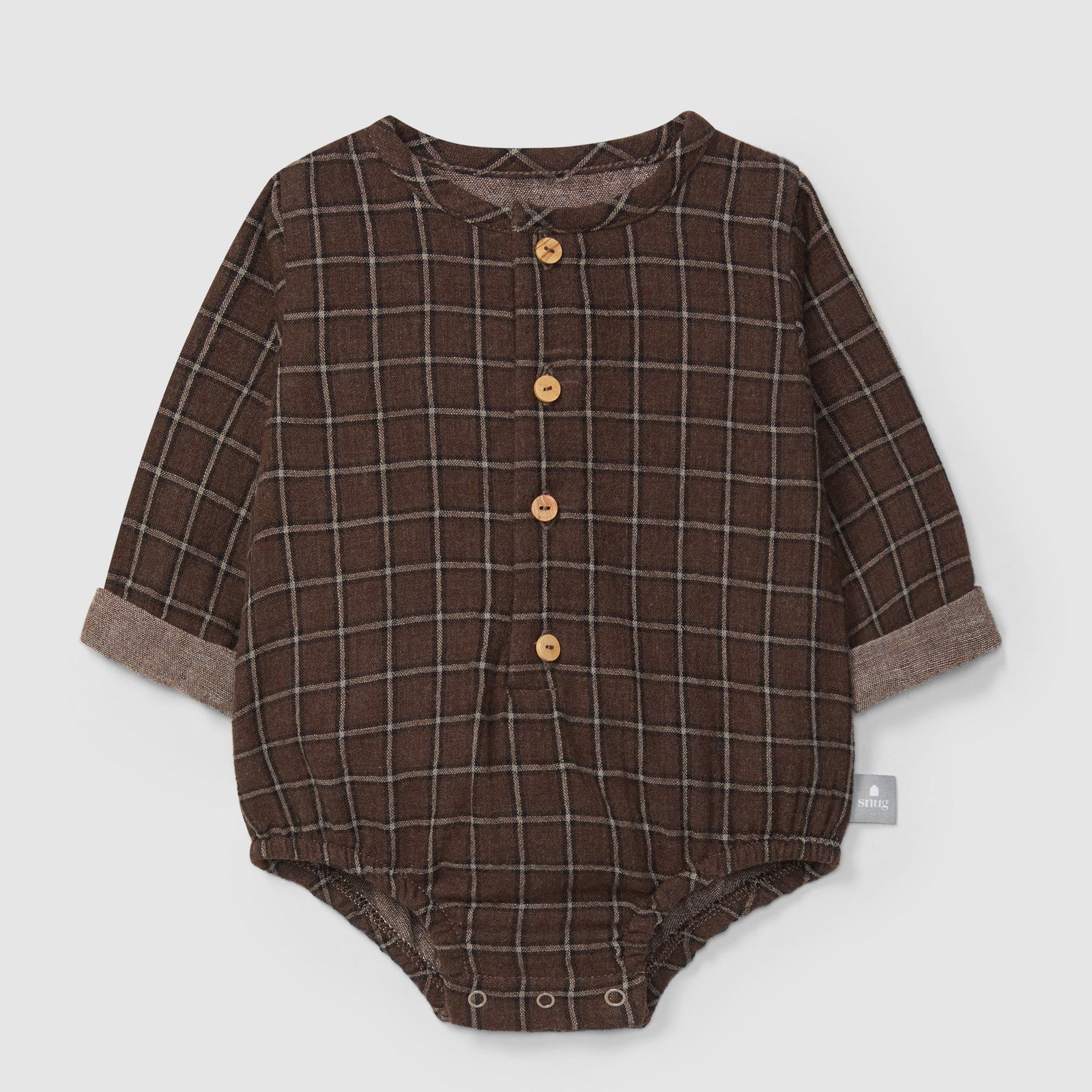 Brown plaid baby romper with buttons on a light gray background