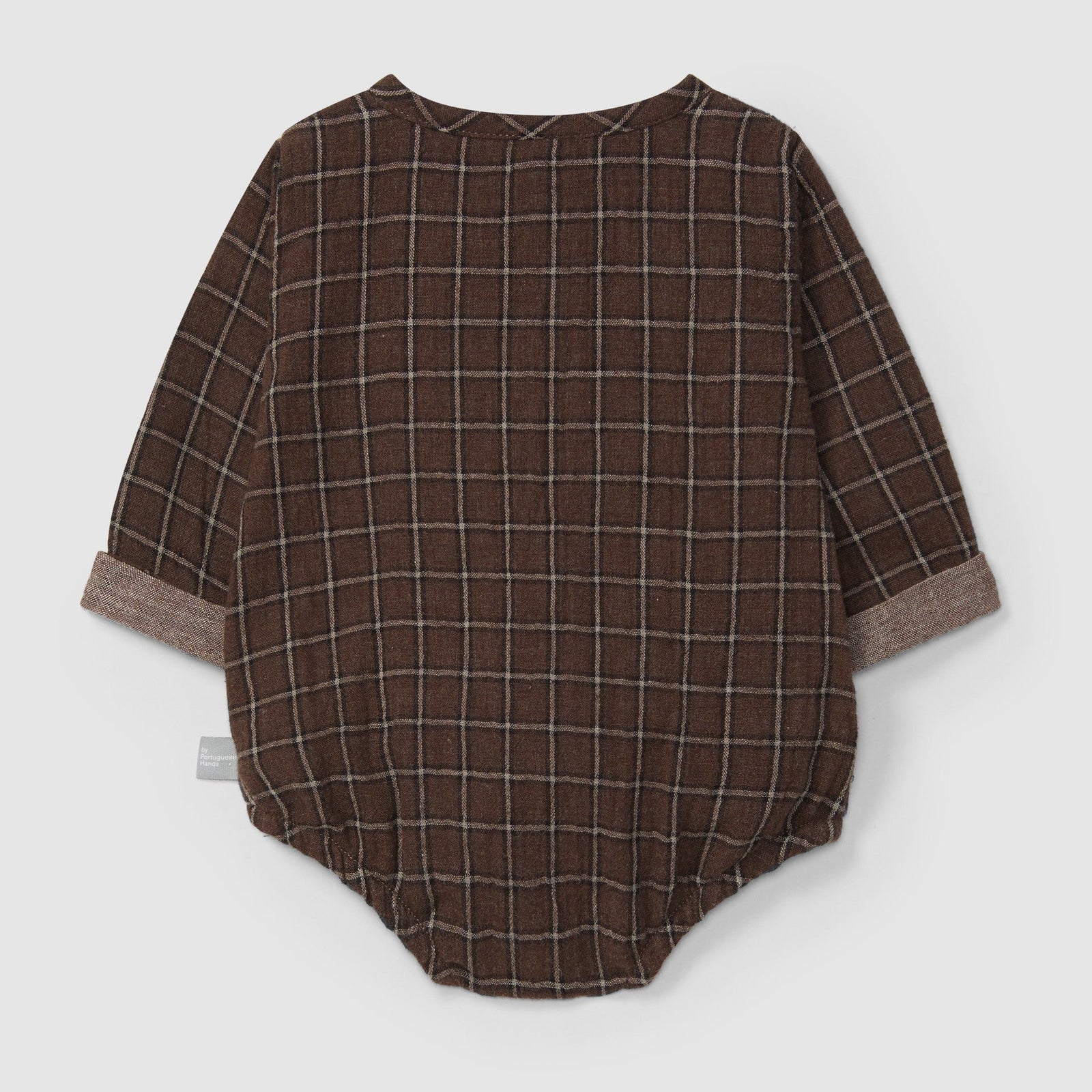 Brown plaid baby romper with buttons on a light gray background