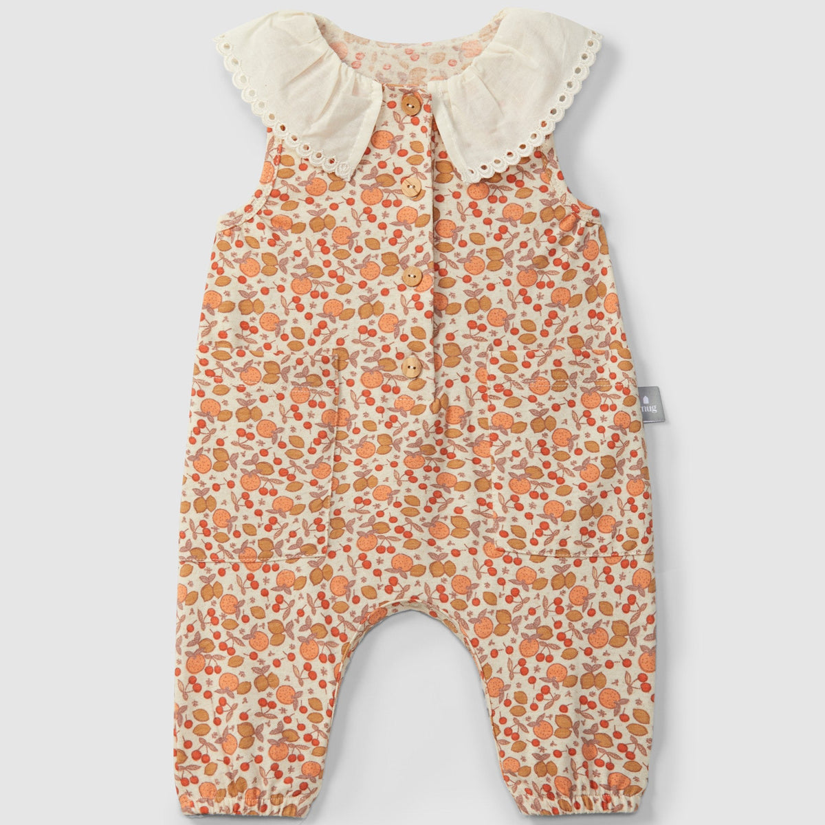 Floral-patterned baby romper with ruffled collar on a light gray background