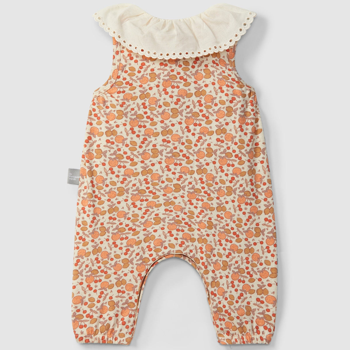 Floral-patterned baby romper with ruffled collar on a light gray background
