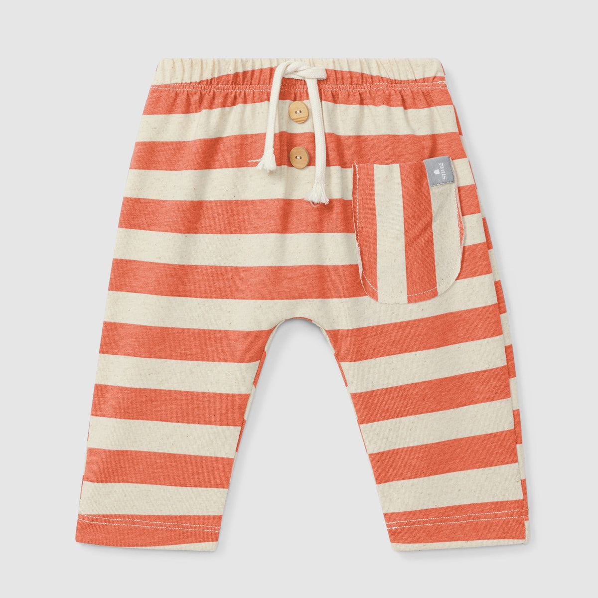 Striped baby pants with buttons on a light gray background