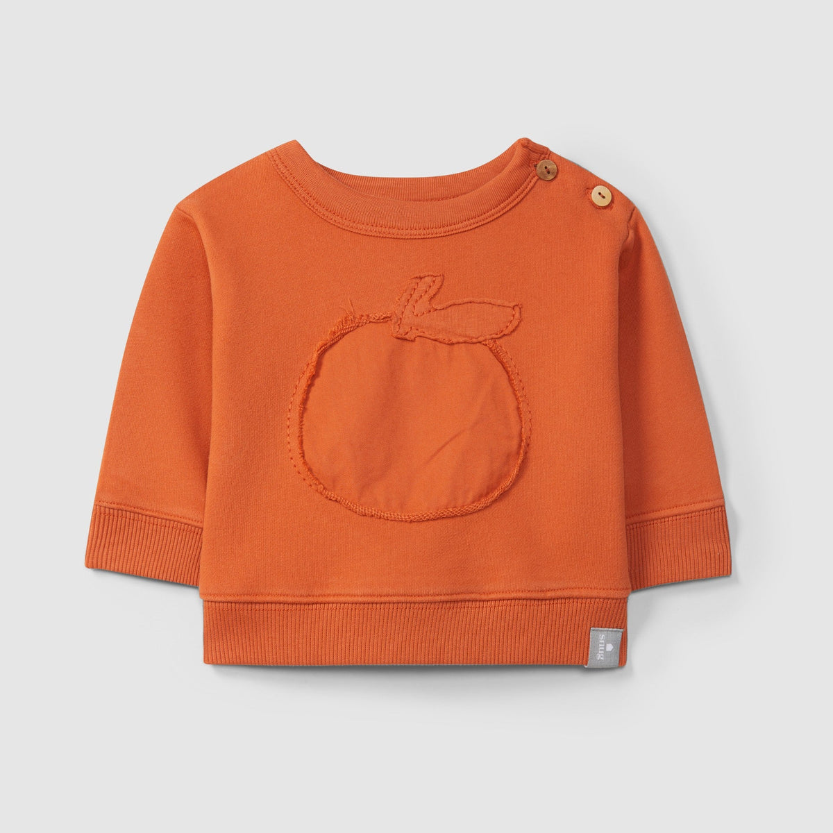 Orange baby sweater with a circular design on a light gray background