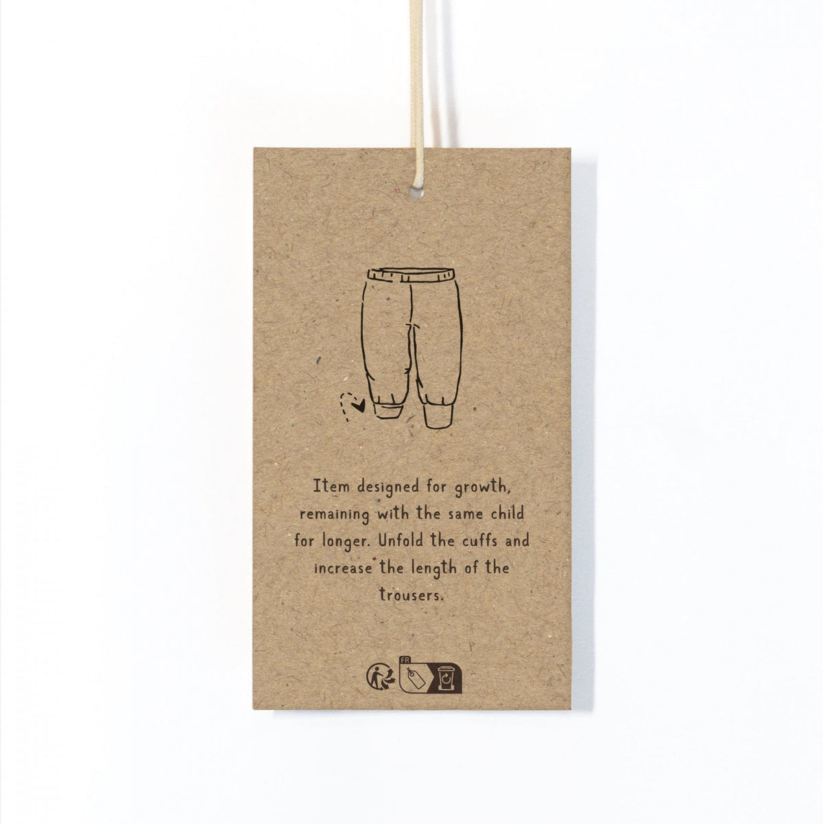 Kraft paper tag with a drawing of pants and text on a white background