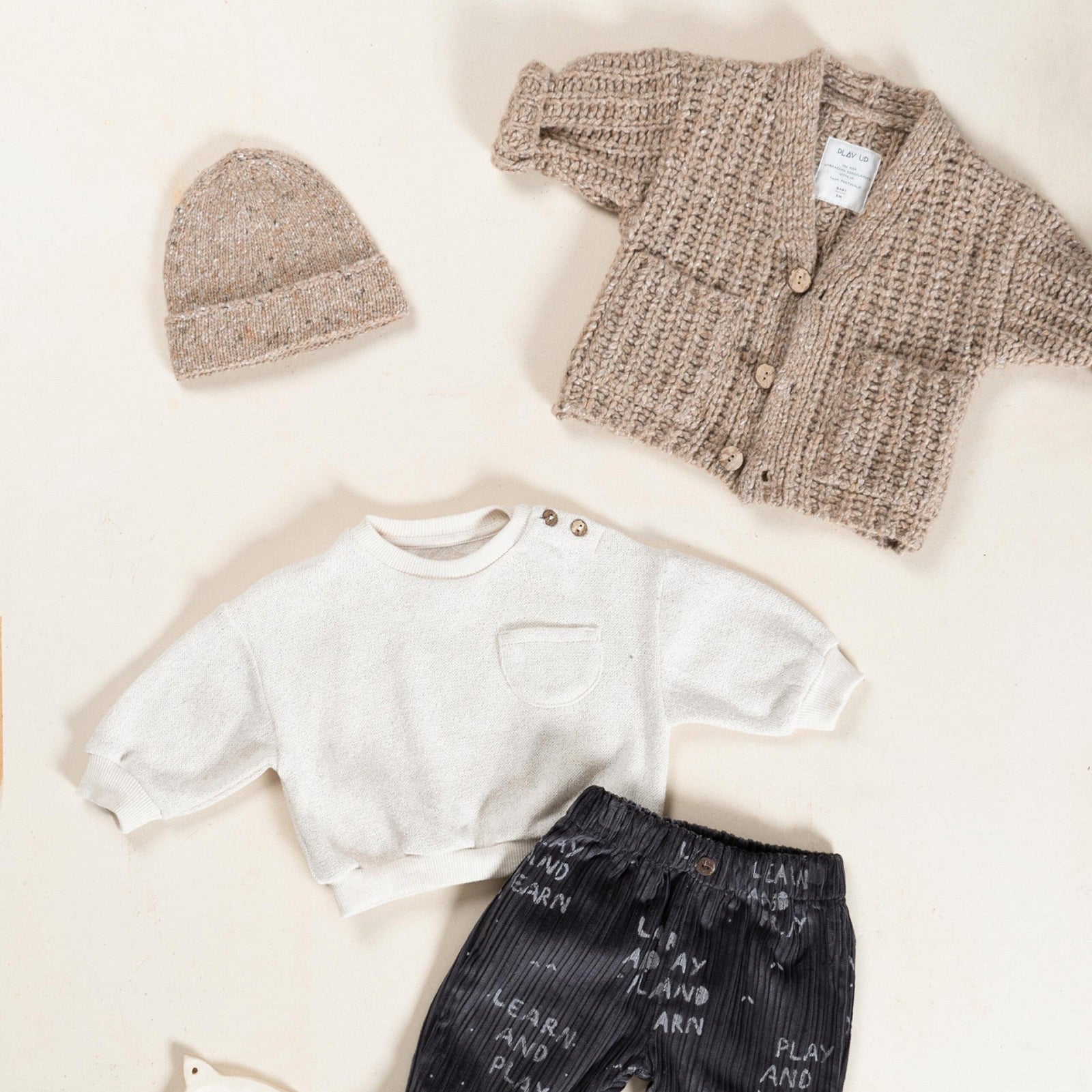 Beige knit beanie on a white background