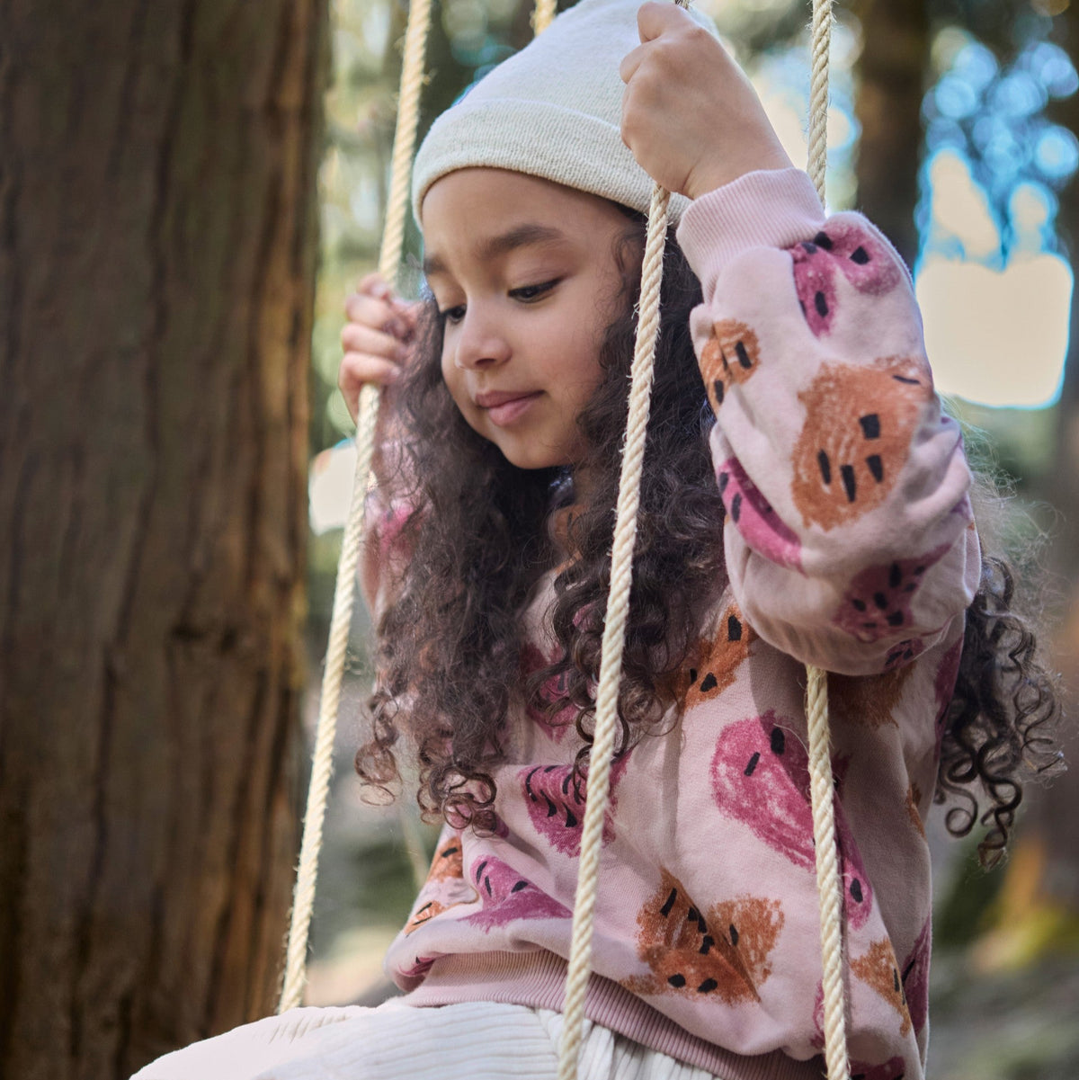 Child sitting on a swing with a blurred background