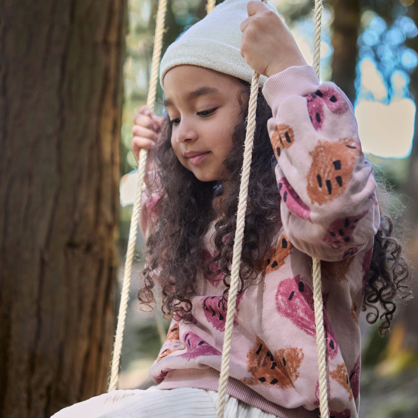 Child sitting on a swing with a blurred background