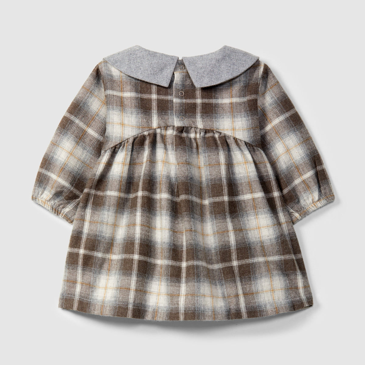 A toddler girl's long-sleeve dress featuring a brown, beige, and white plaid pattern with a contrasting solid gray Peter Pan collar, displayed on a neutral light gray background.