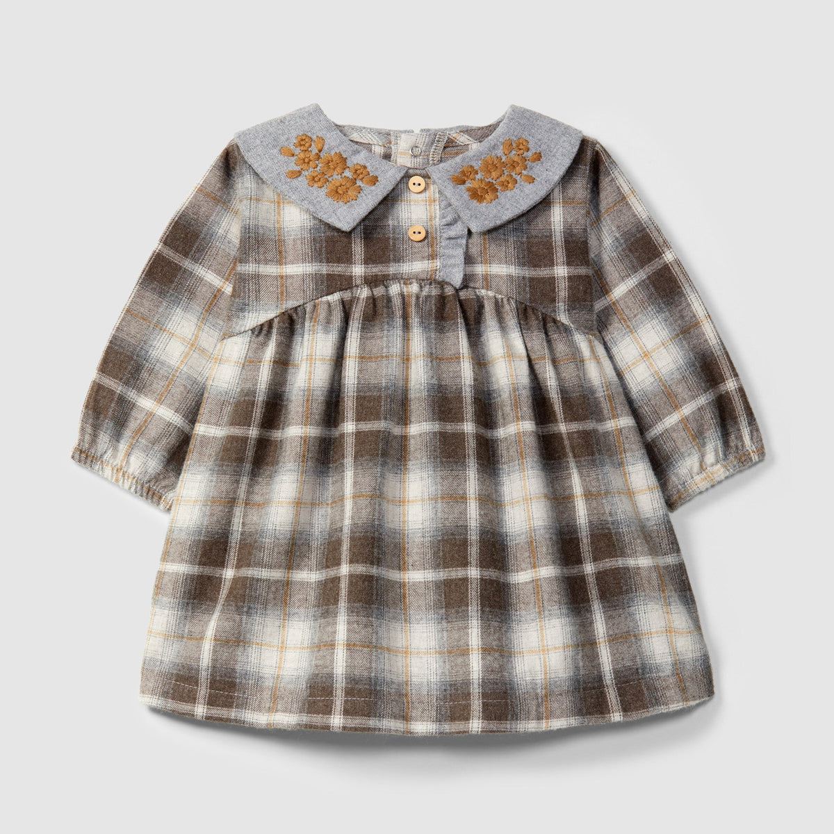 A toddler girl's long-sleeve plaid dress with a grey Peter Pan collar featuring embroidered orange floral details and two small buttons, shown on a light gray background.