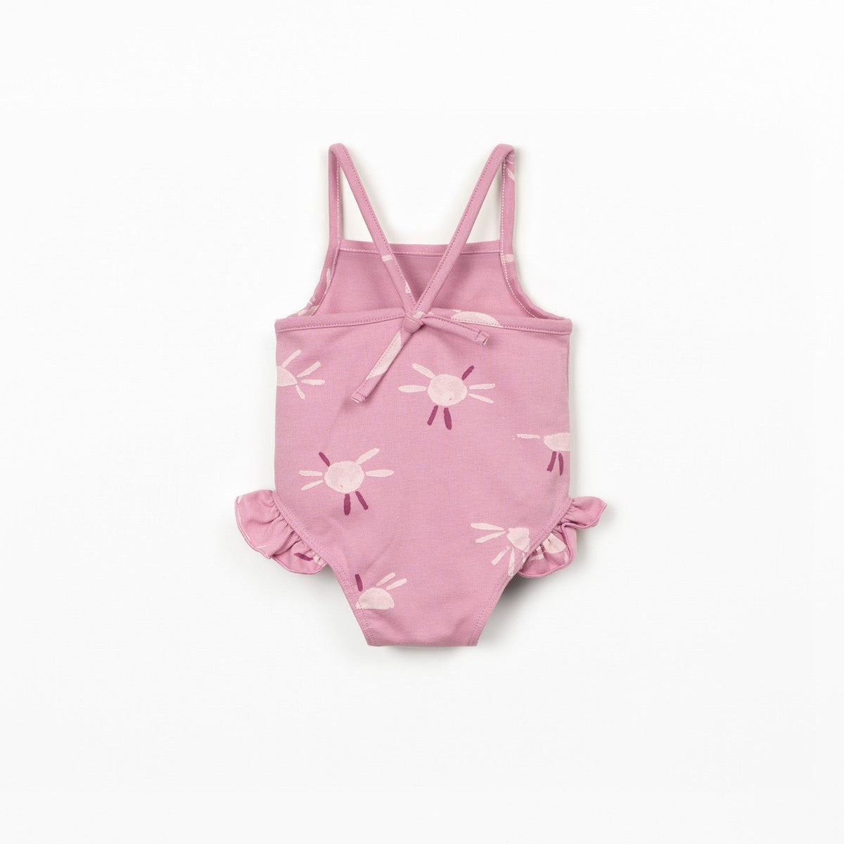 Pink children's swimsuit with sun pattern on a white background