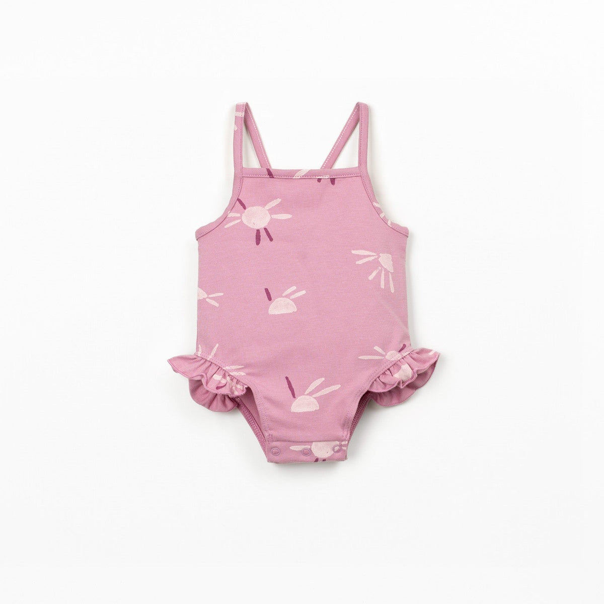 Pink baby swimsuit with sun  patterns on a white background