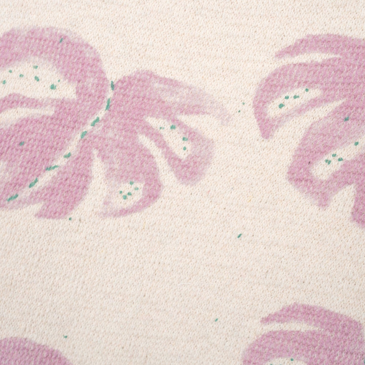 Close-up of pink leaf pattern on a textured white background