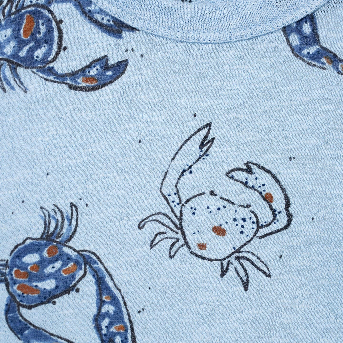 Light blue t-shirt with crab pattern on a white background
