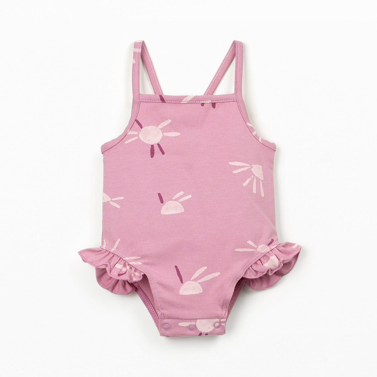 Pink children's swimsuit with ruffles on a white background