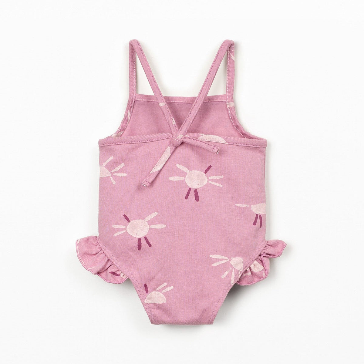 Pink children's swimsuit with sun pattern on a white background
