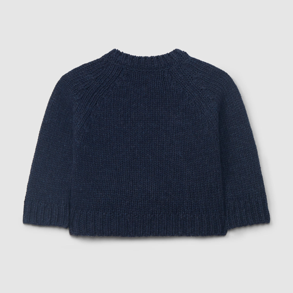 A dark navy blue knit sweater with a crew neck and raglan sleeves, shown from the back against a light gray background.