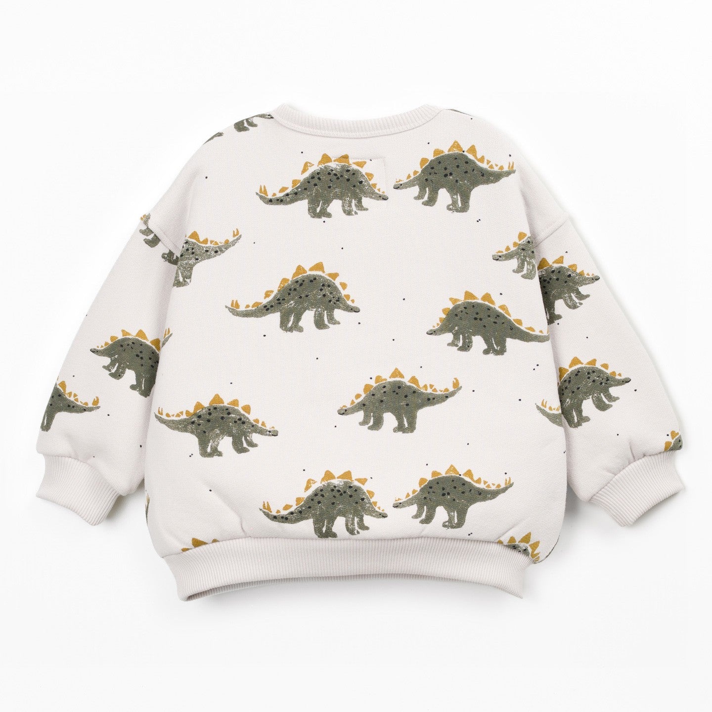 A long-sleeve crewneck sweatshirt for kids, featuring an all-over print of green and brown Stegosaurus dinosaurs with orange-yellow spikes on a warm off-white background.