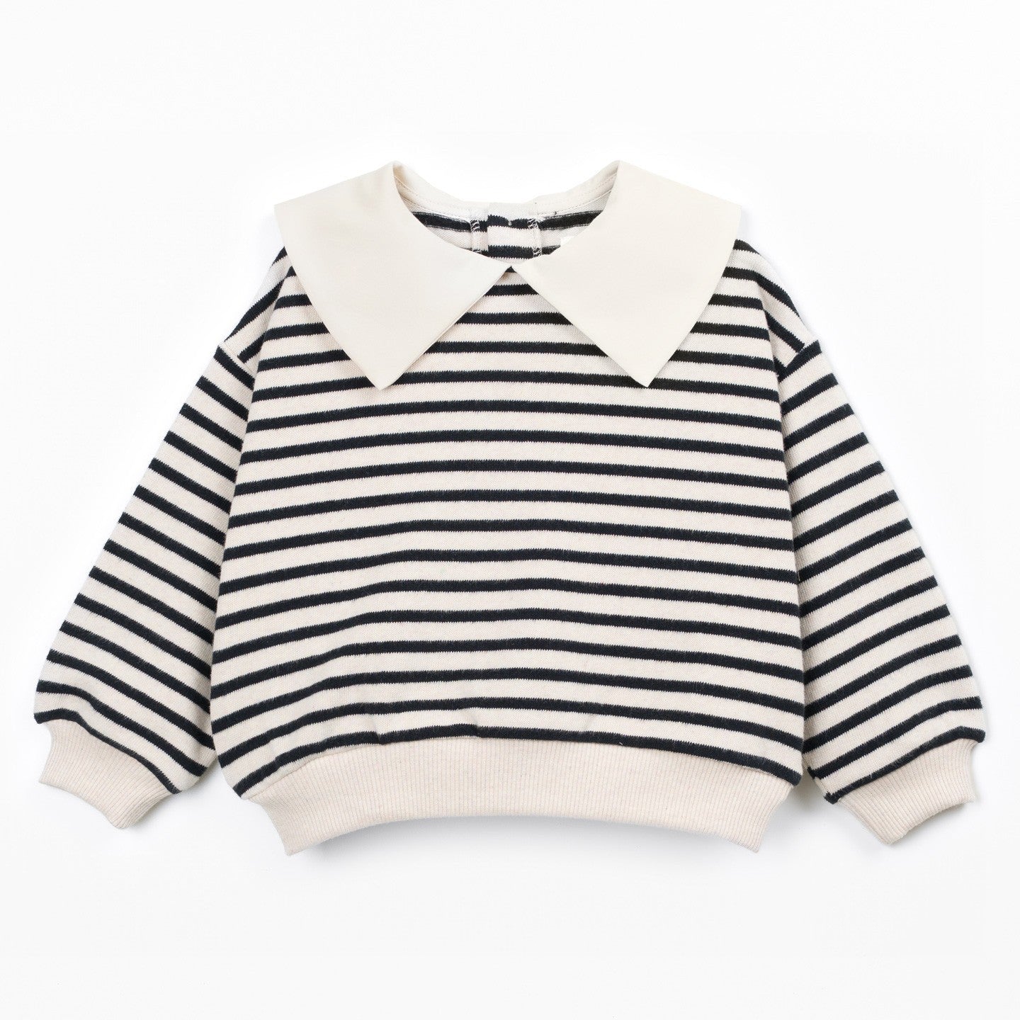 A children's long-sleeve knit top with black and off-white horizontal stripes, featuring a large off-white pointed collar, ribbed cuffs, and a ribbed hem, displayed flat against a white background.