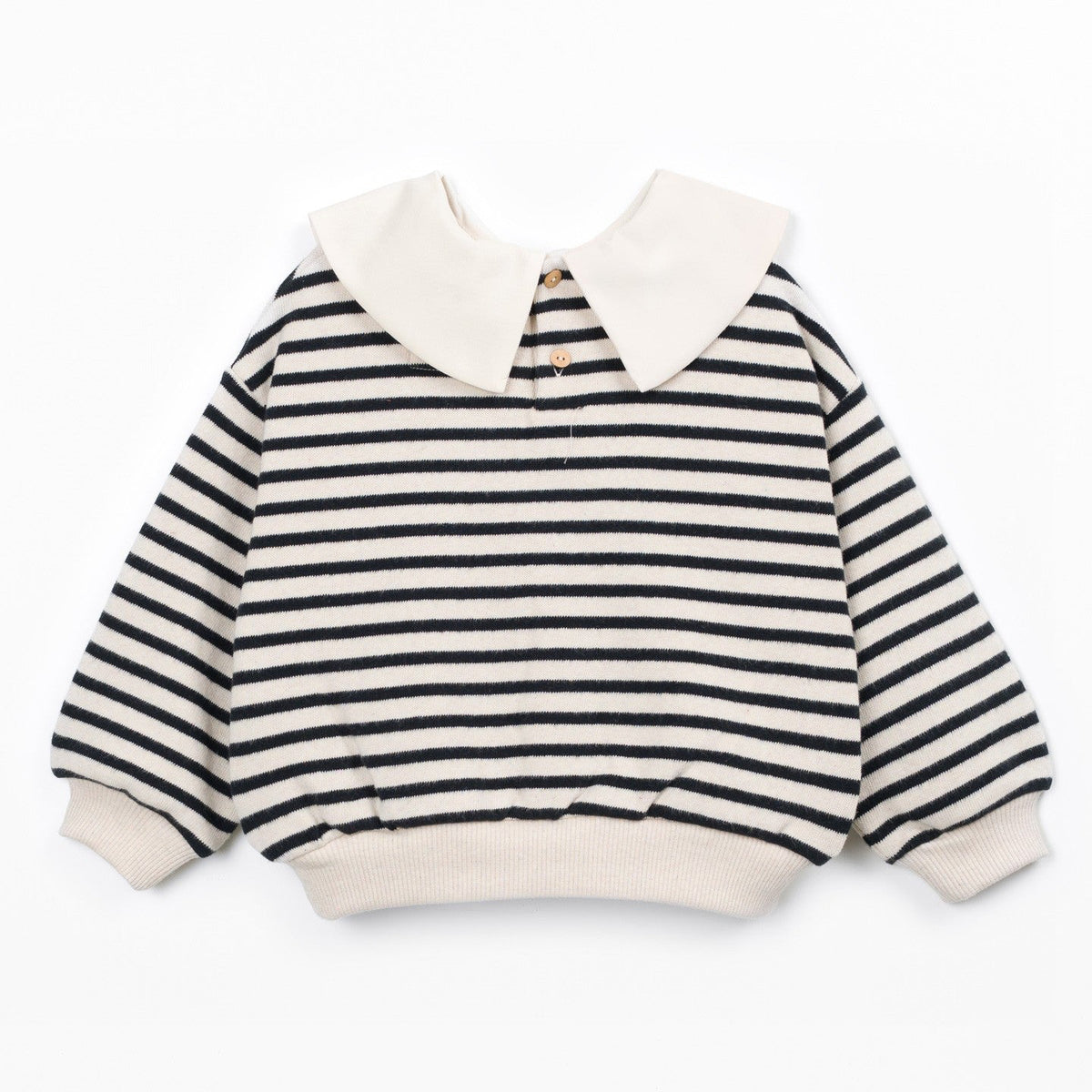 A children's long-sleeve top with horizontal black and off-white stripes, featuring a large off-white Peter Pan collar and matching ribbed cuffs and hem, shown flat on a white background.