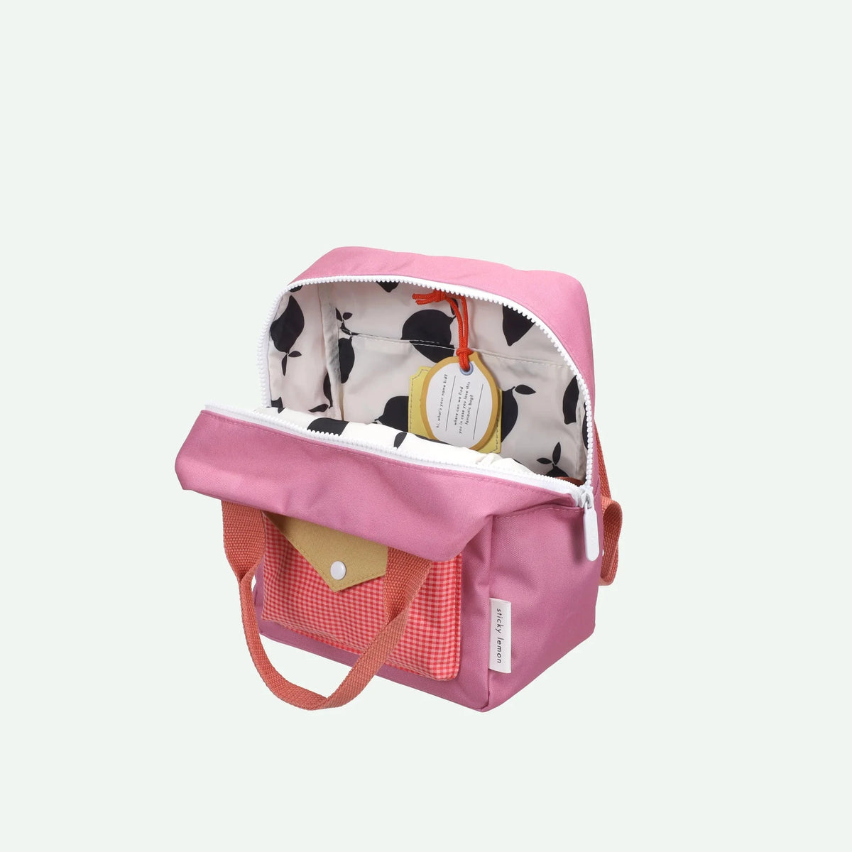 Pink backpack with a patterned interior on a white background