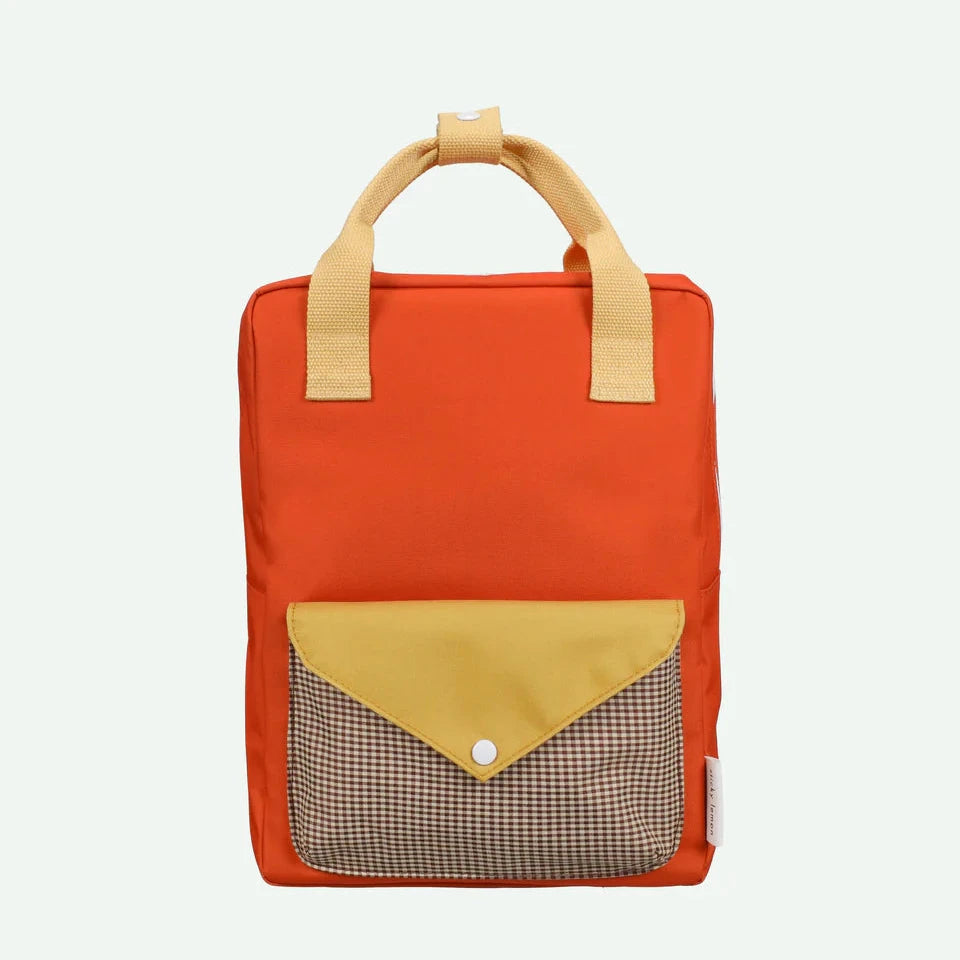 Orange backpack with beige accents on a white background