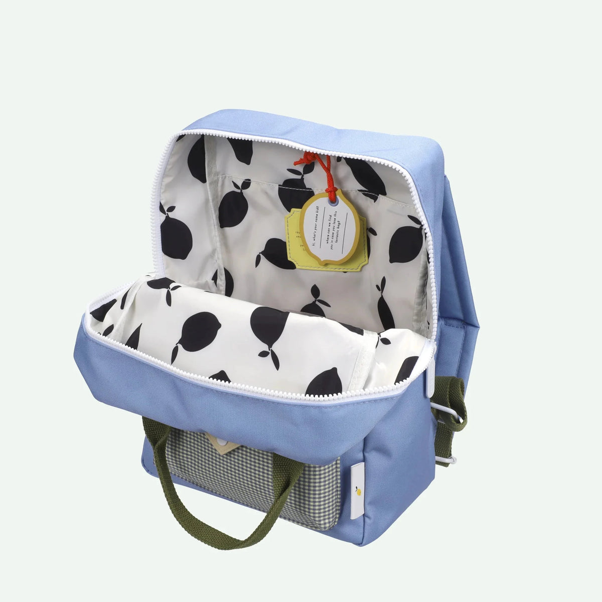 Blue backpack with a polka dot interior on a light gray background