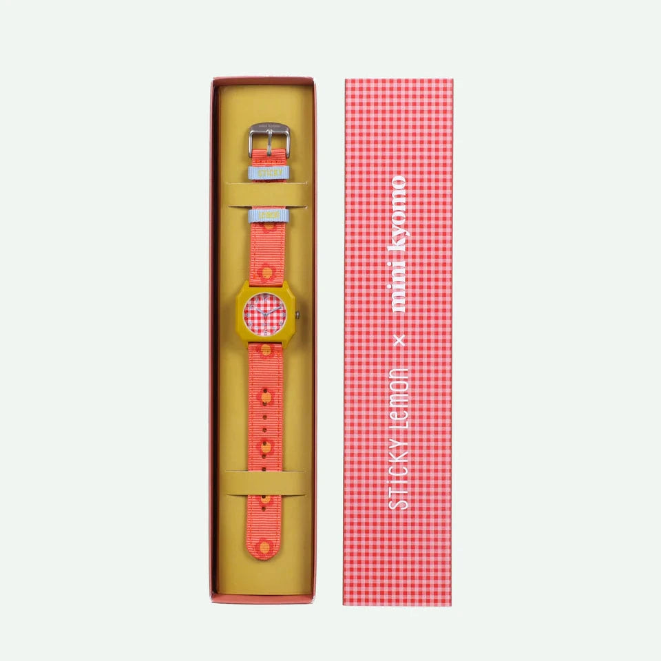 Watch with pink strap and yellow case in packaging on a white background