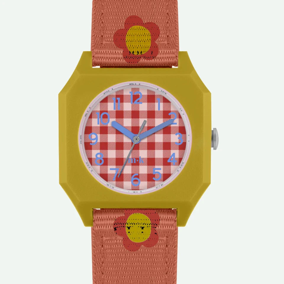 Children's watch with a red and white checkered face, yellow case, and pink strap on a light gray background