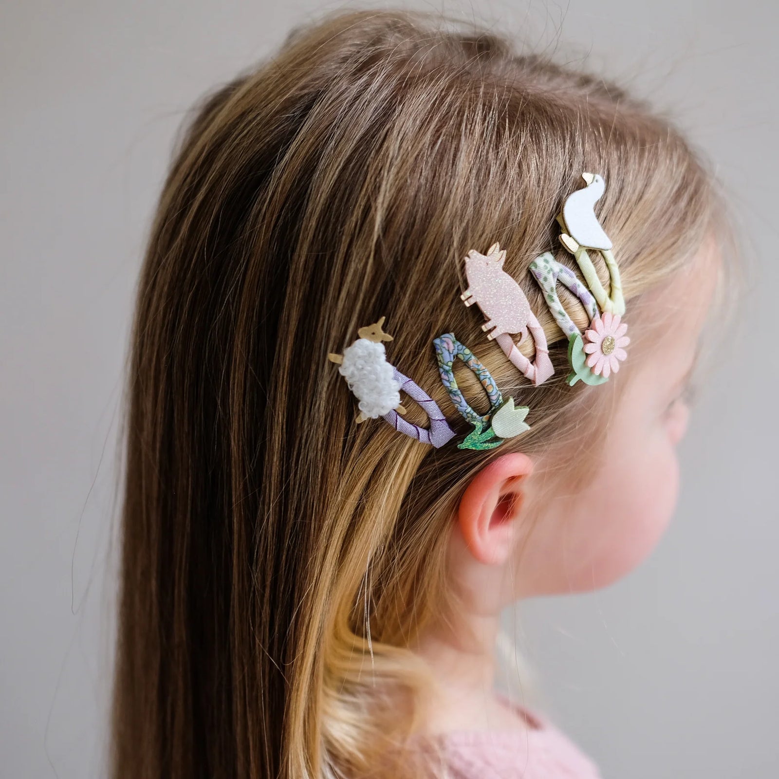 Set of animal-themed hair clips on a white background