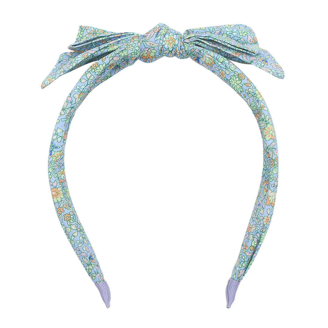Floral patterned headband with a bow on a white background